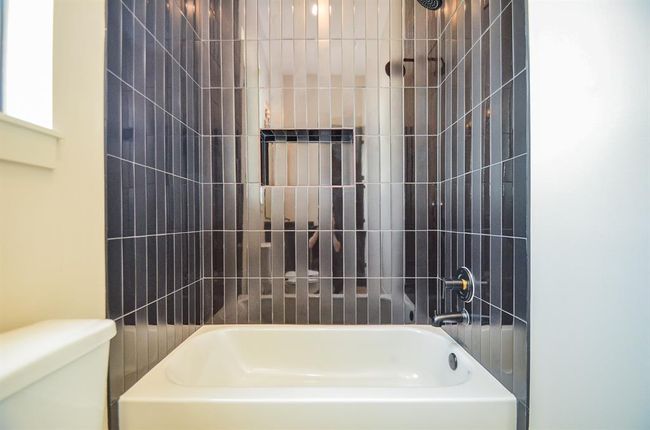 Tub in one of the 3 full bathrooms downstairs. | Image 12
