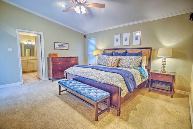Master Bedroom with lofted ceiling, ornamental molding, carpet, baseboards, and ensuite bath | Image 24
