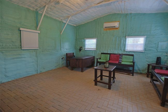 Miscellaneous room with brick floor, a wall mounted air conditioner, and lofted ceiling | Image 29