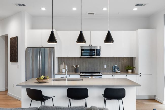 Spacious kitchen with tons of storage, kitchen island that you can eat at, and great light! | Image 6