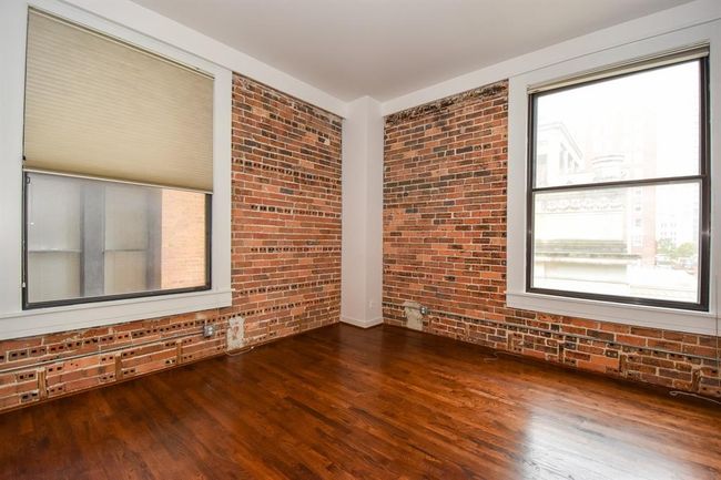 Alternate angle of the primary bedroom, showcasing the generous space and natural light from the large window. The room also features a spacious closet. | Image 24