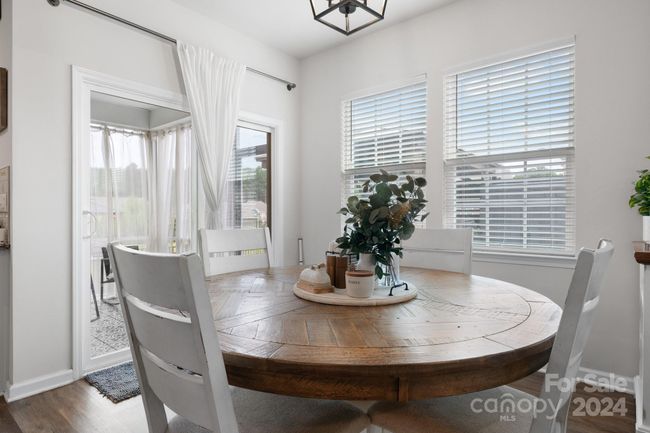 Dining area with sliding doors to screened porch. | Image 10