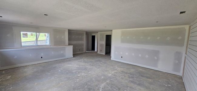 Empty room with concrete flooring and a textured ceiling | Image 13