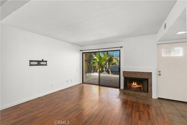 nice wood plank flooring with fireplace | Image 4