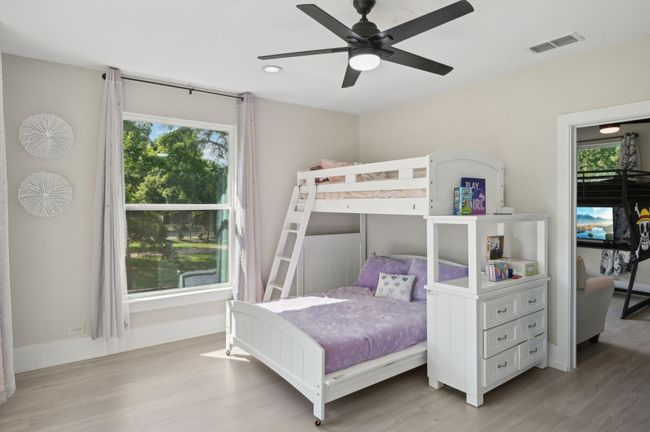 Bedroom featuring light wood-style floors, baseboards, ceiling fan, and recessed lighting | Image 34