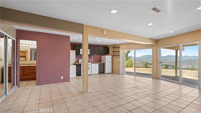 Large room on the lower level with tiled floors - a kitchen, laundry and bathroom. | Image 41