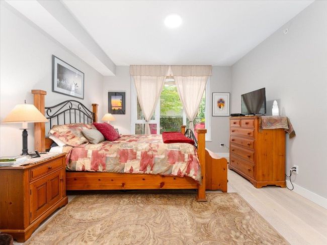 Bedroom with light wood finished floors and baseboards | Image 16