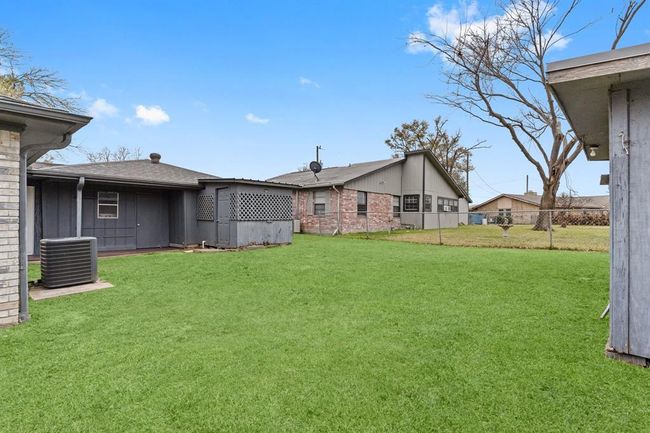 Spacious fenced backyard. Ideal for outdoor activities and relaxation. | Image 34