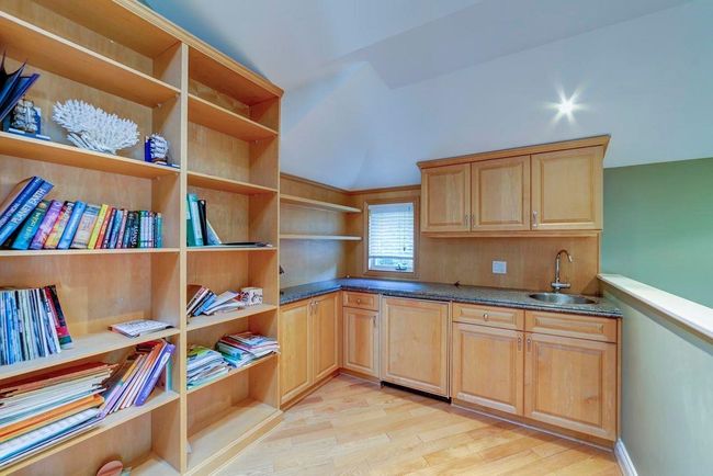 Kitchen with light brown cabinetry, a sink, light wood finished floors, and open shelves | Image 5