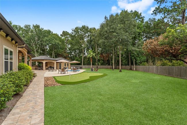 Enjoy complete privacy in this fully fenced backyard retreat with a pool, spa, chef-style outdoor kitchen, and putting green | Image 4