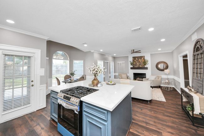 Modern island with breakfast bar & gas range. | Image 10
