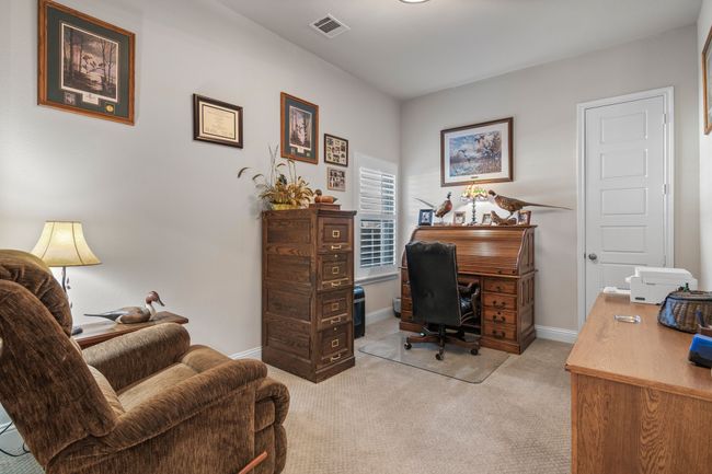 Office with visible vents, light carpet, and baseboards | Image 12
