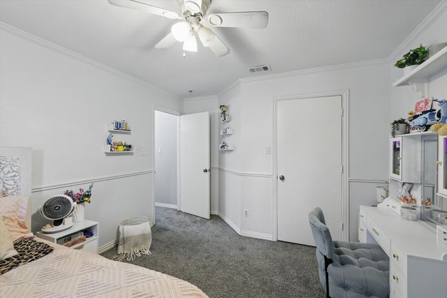 Carpeted bedroom featuring crown molding, a desk, and a ceiling fan | Image 27
