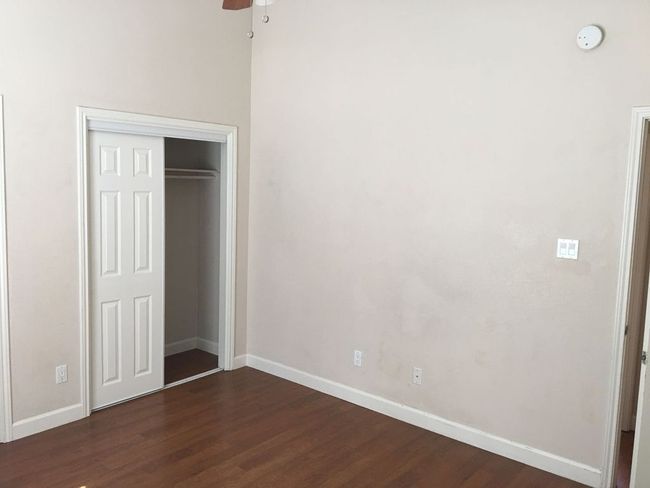 Unfurnished bedroom featuring dark wood-type flooring, a closet, and baseboards | Image 10
