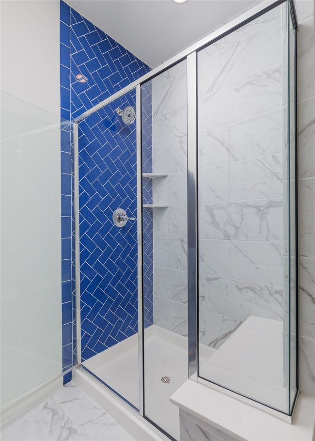 Full bath with a shower stall and marble look tiles | Image 18