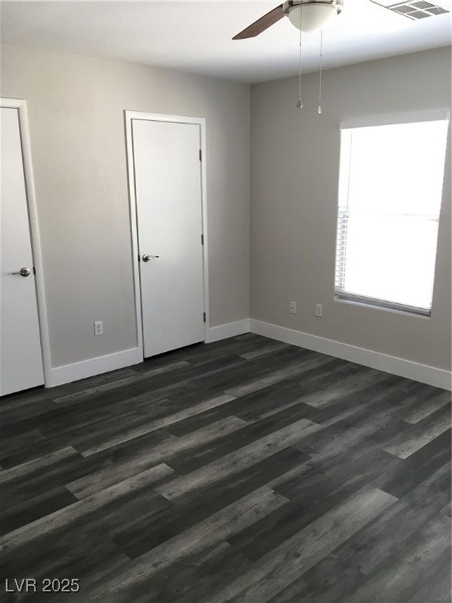 Spare room with baseboards, ceiling fan, and dark wood finished floors | Image 26