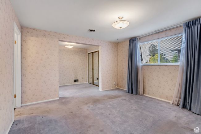 Carpeted spare room featuring wallpapered walls and visible vents | Image 10