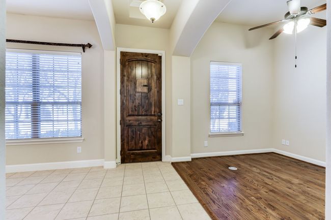 Entryway featuring ceiling fan and wood finished floors | Image 6