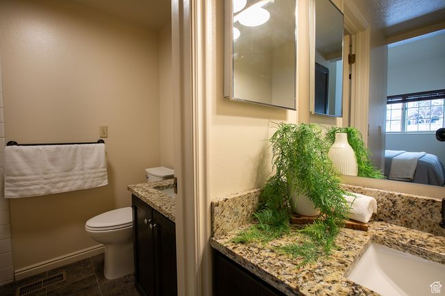 Bathroom featuring vanity, toilet, ensuite bath, and baseboards | Image 16
