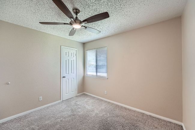 Bedroom #4 offers great natural light and a ceiling fan with remote control. | Image 11