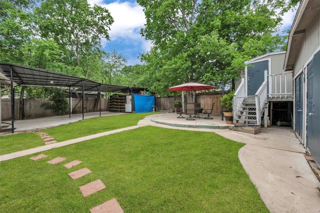 View of yard with stairway, a fenced backyard, and a patio area | Image 4