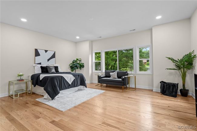 Bedroom with light wood-style flooring and recessed lighting | Image 33