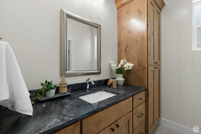 Bathroom with baseboards, vanity, and tile patterned flooring | Image 17