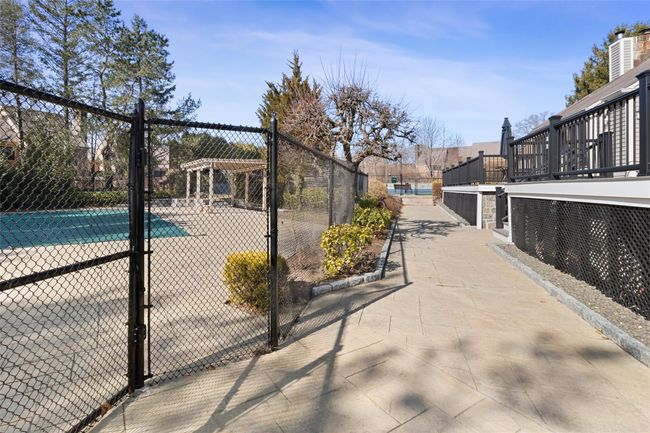 Walkway between the pool, tennis courts, playground and club house | Image 24