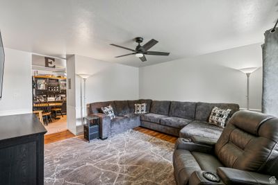 Living room with ceiling fan and wood-type flooring | Image 3