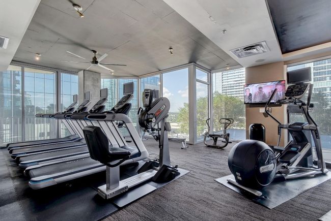 Exercise room featuring expansive windows and ceiling fan | Image 24