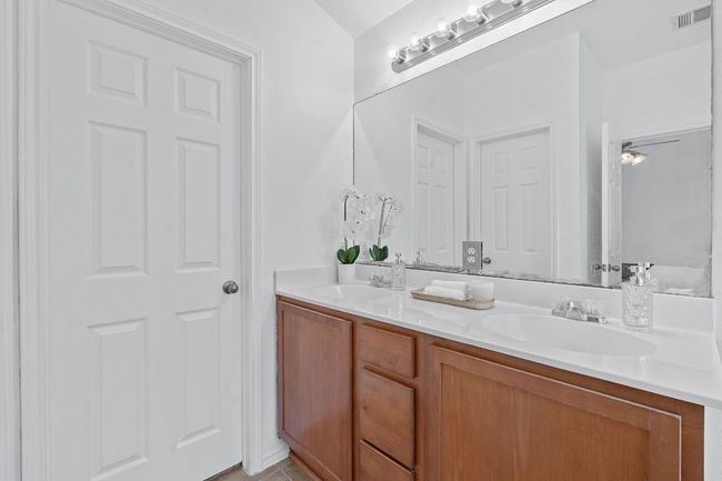 Bathroom with double vanity and tile patterned floors | Image 21