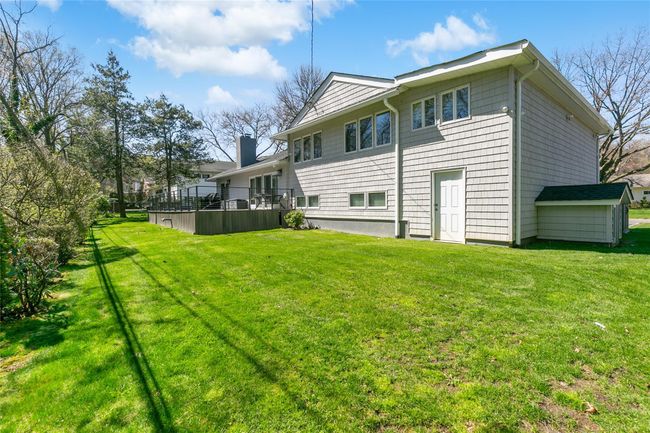 Rear view of property with a lawn and a chimney | Image 32
