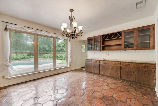 Unfurnished dining area with a chandelier | Image 9