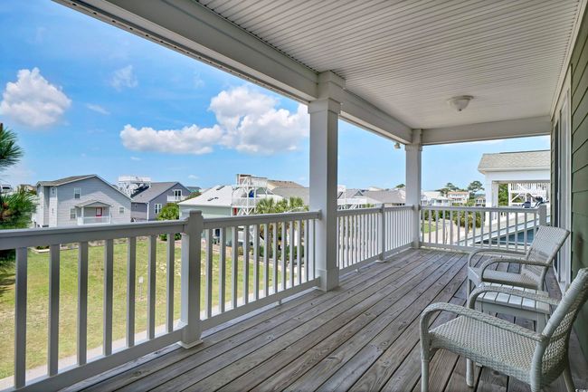 Wooden deck with a residential view and a yard | Image 19