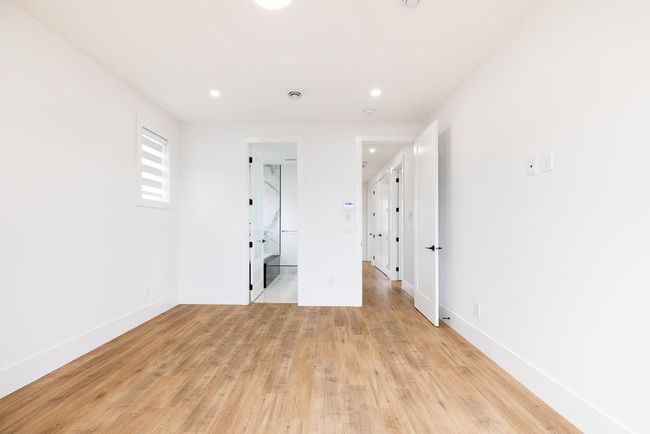 Unfurnished bedroom featuring baseboards, light wood-style flooring, recessed lighting, and connected bathroom | Image 27