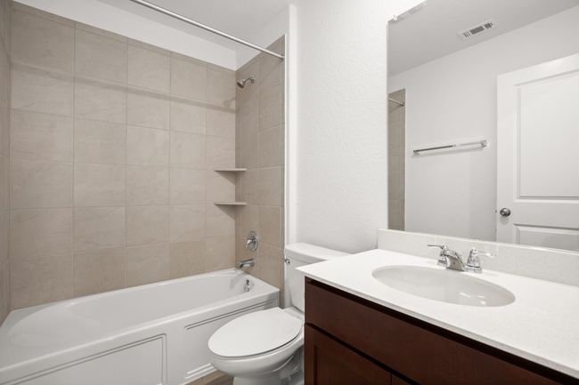 Full bath featuring toilet, vanity, and bathing tub / shower combination | Image 21
