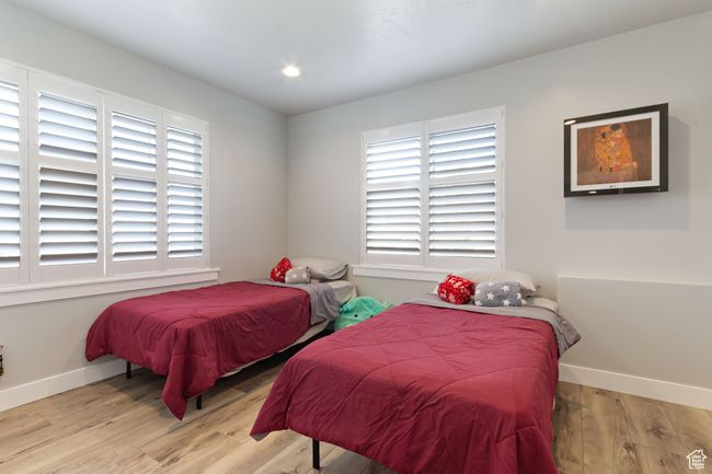 Bedroom featuring baseboards, recessed lighting, and light wood-style floors | Image 27