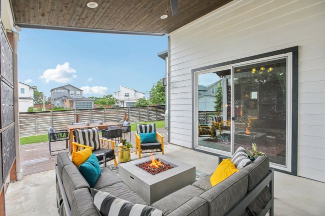 View of patio featuring an outdoor living space with a fire pit and a wooden deck | Image 34