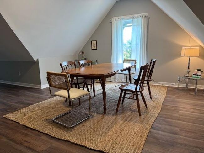 Dining room featuring wood finished floors and vaulted ceiling | Image 25