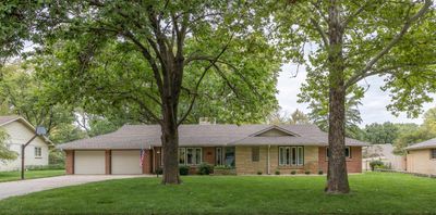 Ranch-style house with a garage and a front yard | Image 1