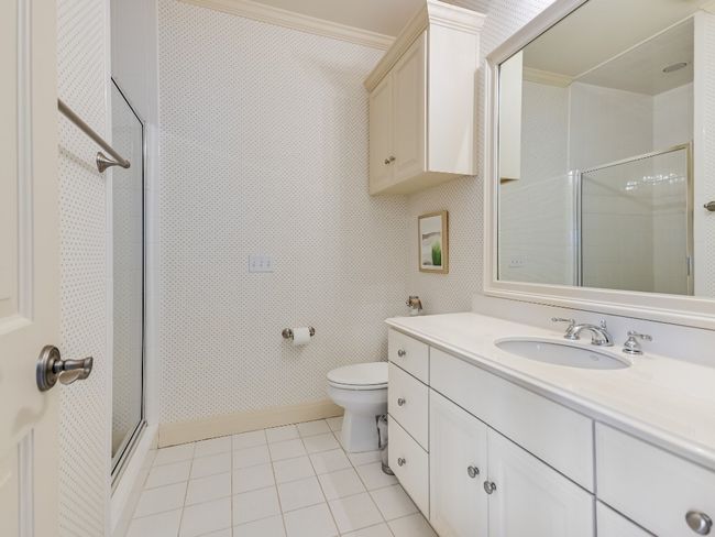 Full bath with a stall shower, vanity, toilet, tile patterned flooring, and crown molding | Image 18