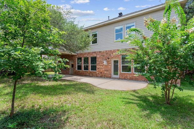 Back of house featuring brick siding, a patio area, and a yard | Image 39