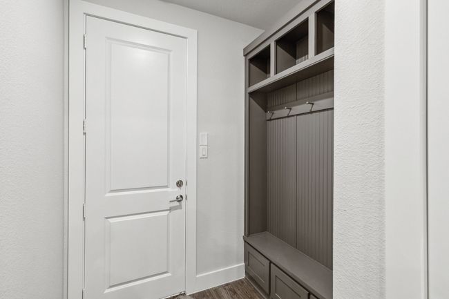 Mudroom with dark wood-style floors and baseboards | Image 11