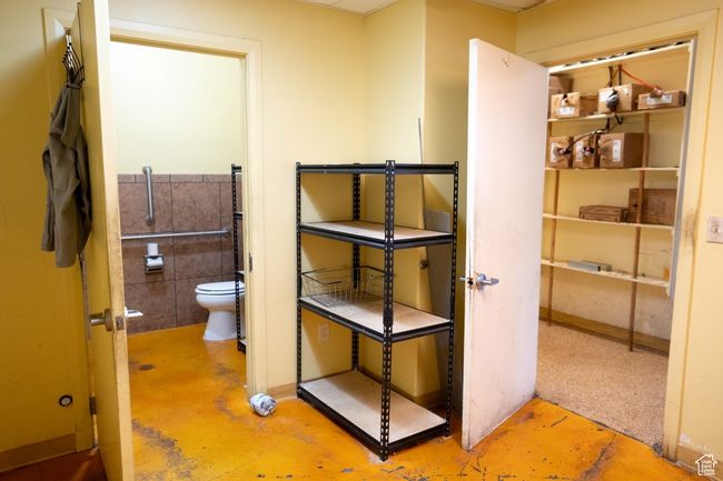 Bathroom with toilet and finished concrete floors | Image 30