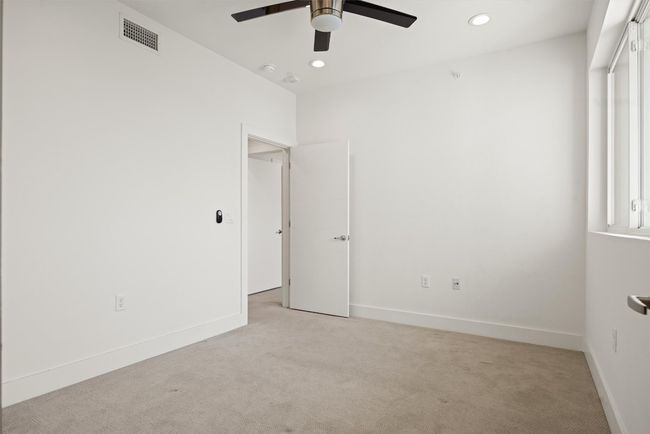 Guest room with light colored carpet, ceiling fan, and recessed lighting | Image 16
