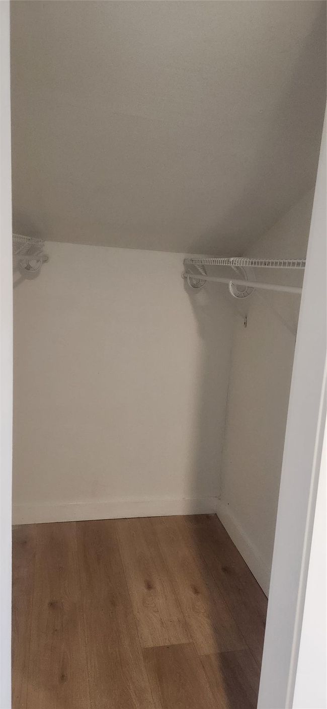 Walk in closet with wood finished floors | Image 28