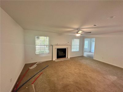 Living room with Gas Fire Place, well lit and overlooking the pond | Image 3