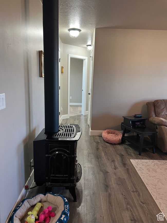 Hallway featuring wood finished floors and a textured ceiling | Image 39