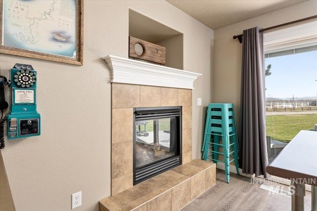Detailed view of wood finished floors and a tiled fireplace | Image 8