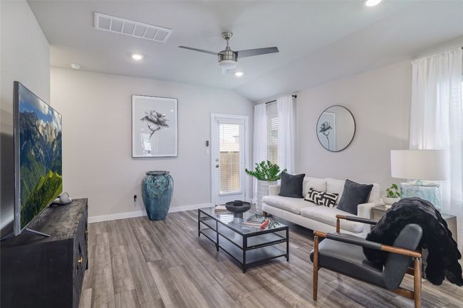 Living room with wood finished floors, a ceiling fan and recessed lighting | Image 6